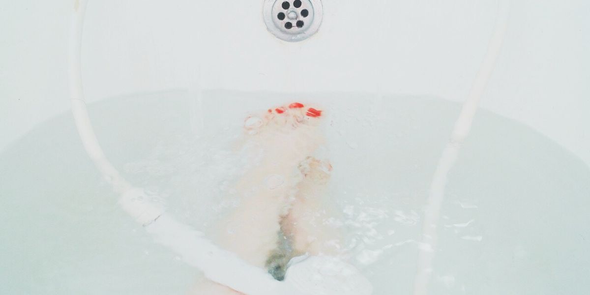 Soaking feet in warm bath water